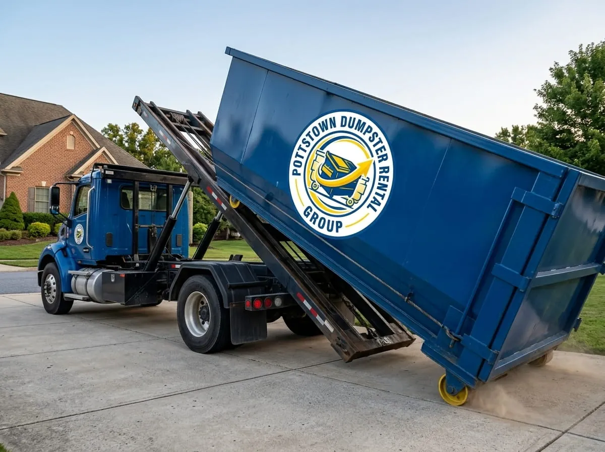 Heavy demolition dumpster being loaded onto a truck in Pottstown, PA